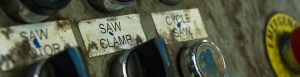 Dusty saw clamp labels stick to machinery.