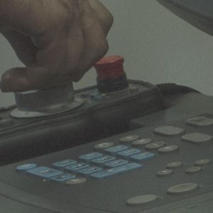 Employee presses buttons on a switchboard.