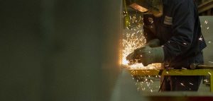 View of worker using an angle grinder
