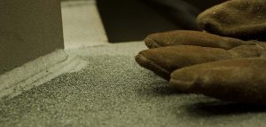 detail of glove and sandblasting dust