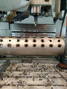 Close-up of a boiler component being drilled by a CNC machine at Helfrich Brothers Boiler Works.