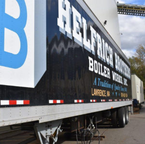 Side view of a Helfrich Brothers Boiler Works trailer with company branding in a parking lot.