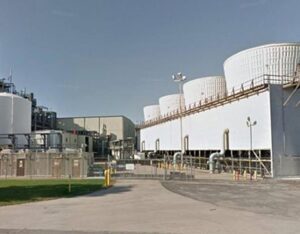 A large industrial cooling system with multiple cylindrical cooling towers and connected pipelines.